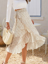 Side pose of model in Faylora Drift Skirt pastel yellow, showcasing flowing ruffled hem and botanical floral print in motion