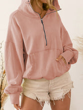 A model wearing the peach color Nuvella Zip-Up Dropped Shoulder Hoodie paired with distressed tan denim shorts.