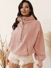 A model wearing the peach color Nuvella Zip-Up Dropped Shoulder Hoodie paired with distressed tan denim shorts.