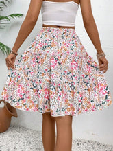 Back view of pink Florévyn Midi Skirt showcasing frill tiers and ruffled hem