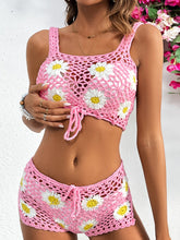 Close-up of white crochet flower cutout detailing on Pink two-piece cover up made from soft, stretchy fabric.