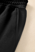 close up of pocket and elastic drawstring waist on black pockease active joggers