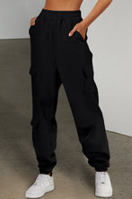 front view of pockease active joggers in black with hands in upper side pockets