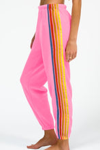 PrismFlow Active Pants pink side view showing contrast stripes and tapered leg