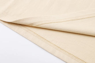 Detailed close-up of khaki PureForm Luxe Cotton Tee bottom hem stitching showcasing durability and precision