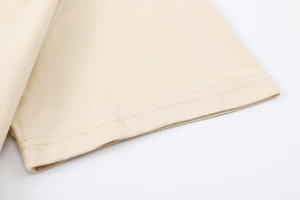 Close-up of khaki PureForm Luxe Cotton Tee sleeve showing premium stitching and clean seam finish