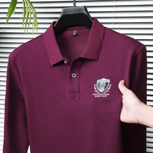 Close-up front view of purple Equestrian Crest Designer Polo on hanger showing embroidery, buttons, and flip color-contrast collar