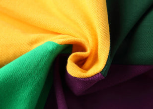 Swirled close-up of Purple RegaliaSport Elite Polo premium cotton fabric showing soft texture and breathable weave.