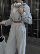 Close up of QeNora Zip & Pocket Set Light Gray styled with luggage bag