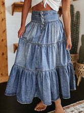 Close-up of button-fly closure and tiered ruffle detail on Raventa Denim Skirt