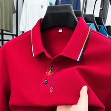 Close-up front view of red Royale Crest Fleur de Lis Polo showing embroidered placket detail.