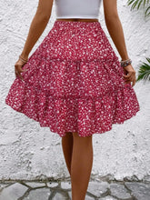 Back view of red Florévyn Midi Skirt showcasing frill tiers and ruffled hem
