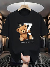 Regal K Bear Black Graphic Tee on hanger in luxury closet.