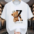 Regal K Bear White Graphic Tee on hanger in luxury closet.