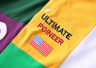 Close-up of RegaliaSport Elite Polo designer letter embroidery and US flag accent.