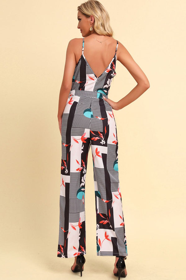 Back view of the Rexéa jumpsuit showcasing the plunging back and adjustable straps, with floral patterns in focus.