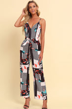 Rexéa jumpsuit showcasing straps, floral design, and waist tie.