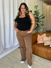 Front view of model showcasing pocket detail of coffee brown RFM Full Size Wide Leg Jeans. 