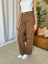 Side view of model in RMF Wide Leg Jeans highlighting pockets, button zip closure, and quality fabric.