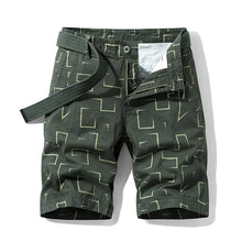 Green abstract print men’s safari Bermuda shorts front view.
