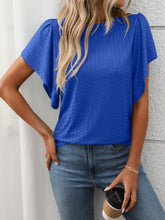 Model wearing a Round Neck Flutter Sleeve T-Shirt in royal blue, styled with white jeans and hoop earrings for a casual-chic daytime look.