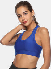 Royal blue cutout active tank side profile on woman.