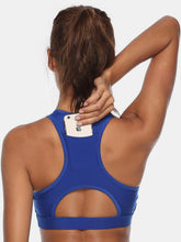 Close-up of royal blue active tank cutout neckline and hidden pocket.
