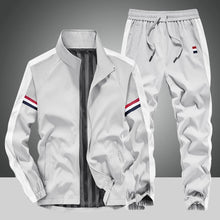 Front view of the Gray Royale Flux Crownstripe 2 Piece Tracksuit by NyxeAura Royale, featuring full-zip stand-collar jacket, contrast side stripes, pockets, and red-white-navy pants logo.