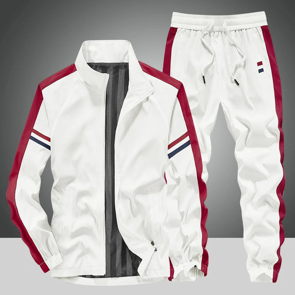 Front view of the White Royale Flux Crownstripe 2 Piece Tracksuit by NyxeAura Royale, featuring full-zip stand-collar jacket, contrast side stripes, pockets, and red-white-navy pants logo.