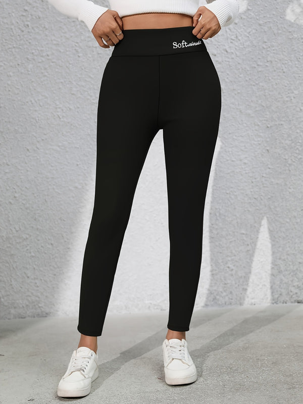 Model wearing Royale Reflect Elevé Black Leggings, front view showcasing embroidered waist detail.