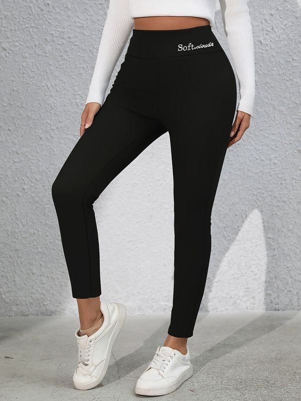 Model stretching in studio wearing Royale Reflect Elevé Black Leggings and sports bra.