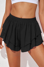 Ruffira Flow Active Shorts front view in black with layered detail.