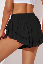 Ruffira Flow Active Shorts rear view in black showcasing mid-rise waist.