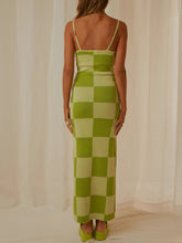Back view highlighting the chic pattern details of the Sage Luxnometry Maxi Sweater Dress in a mansion setting.