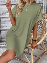 Woman seated at a garden brunch wearing Sage Rahluna Mini Tee Dress paired with a cropped cardigan and ballet flats.