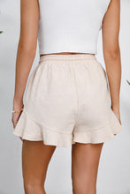 Rear view of sand Plus Size Drawstring Ruffle Hem Shorts highlighting relaxed fit and breezy cotton fabric.