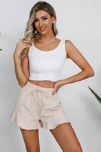 Side angle of sand Plus Size Drawstring Ruffle Hem Shorts with flouncy ruffle detail and comfortable high-rise waist.