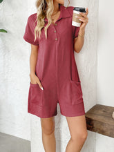 Side view of model in scarlet romper showing button detail and pockets.