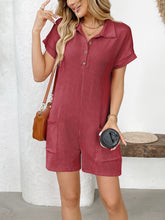 Woman in scarlet Button Detail Collared Neck Short Sleeve Romper styled with accessories at a coffee shop.
