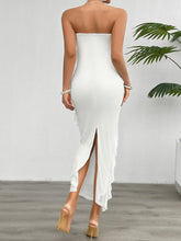 Back view of the White Seraflore™ Maxi Dress, displaying the airy back slit and delicate ruffle detail.