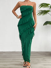 Model styling the Dark Green Seraflore™ Maxi Dress with metallic heels, emerald earrings, and layered rings.