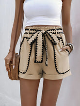 Front view of Seravelya Wave Shorts in tan with model’s hand in pocket