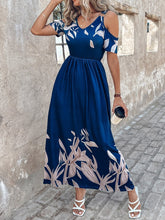Woman dancing at a casual garden party wearing the Navy Blue Serene Xymeraeh™ Maxi Dress, accessorized with statement earrings and sandals.