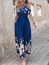 Woman strolling through sunlit streets in Italy, wearing the Navy Blue Serene Xymeraeh™ Maxi Dress with accessories and one hand in pocket for an effortless vacation look.