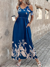Close-up of a woman highlighting the pocket and cold shoulder details of the Navy Blue Serene Xymeraeh™ Maxi Dress while holding a takeaway coffee cup.