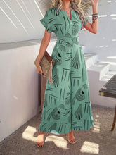 Front view of Serenoor jumpsuit in gum leaf highlighting all-over print, accessorized with tan clutch and open-toe heels at a beach house.