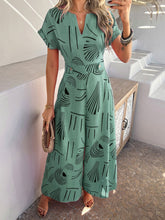 Gum leaf Serenoor jumpsuit paired with tan heels and accessories, worn by model while browsing a seaside farmers’ market.