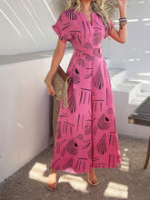 Hot pink Serenoor jumpsuit styled with woven clutch and jewelry, worn by model while dancing barefoot on a beach deck under string lights.