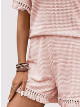 Close-up of blush pink waffle knit and tassel trim.