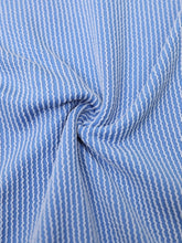 Close up view of sky blue romper showing the high quality design and textured fabric.